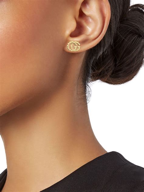 gucci gold stud earrings.